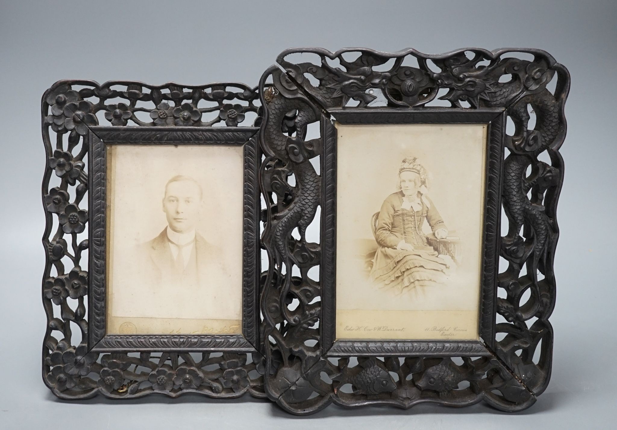 A Chinese carved hongmu ‘dragon’ photo easel frame and a similar ’prunus’ frame, c.1900 (2), Dragon frame 27 cms high x 22cms wide.